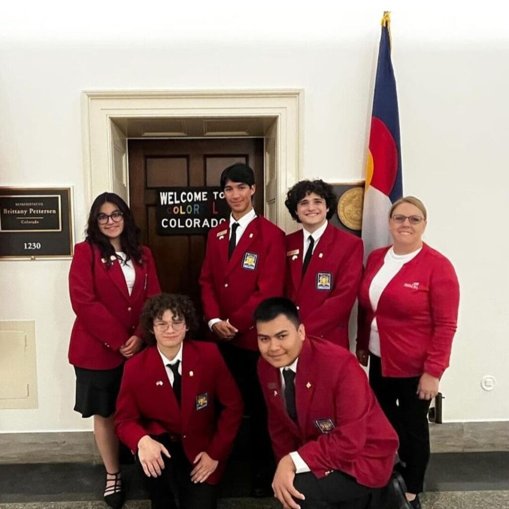Students in red uniform taking a group photo