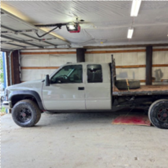 Flatbed pickup truck parked inside a garage.