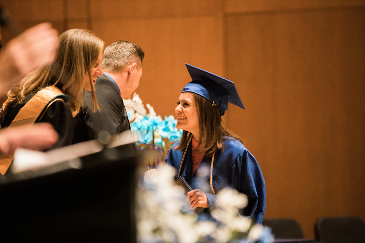 Student receiving her diploma in graduation