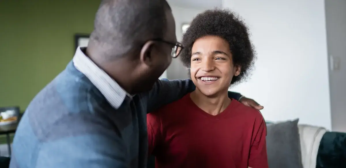 boy and his father looking each other