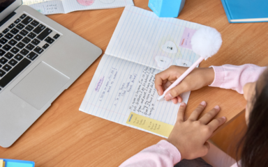 Girl writes in notebook